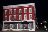 A premium quality art print of Cooperstown Red Brick Building with White Trim at Night