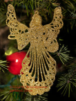 An art print of a Gold Christmas Angel and Red Apple hanging from the tree