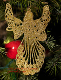 An art print of a Gold Christmas Angel and Red Apple hanging from the tree