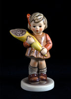 A Goebel Hummel figurine titled A Sweet Offering from trademark 7