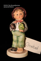 A larger Hummel Figurine Lost Stocking with the original label on the back of the base and the Goebel hang tag. This small German child figure has the trademark 6 on the bottom