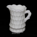 A small Kanawha hand blown milk glass creamer with indented oval designs