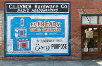  A premium quality print of a cool advertisement for Eveready Radio Batteries on the side of a hardware store painted on the bricks
