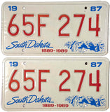 A pair of classic 1987 South Dakota Car License plates issued by the SD DMV in celebration of the state's centennial for sale by Brandywine General Store in excellent condition