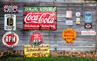 A premium art print of Shell Oil, Coke, Ivory Soap and more Ads nailed to a shed