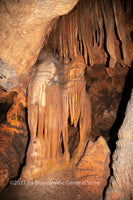 An art print of a small chasm in Luray Caverns with ribbons hanging from the ceiling resembling smoked sides of bacon