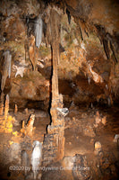 art print of a thin stalactite looking as if it is holding up the ceiling in Luray Caverns