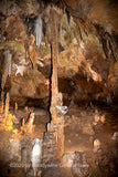 A fine art print of a thin stalactite looking as if it is holding up the ceiling in Luray Caverns