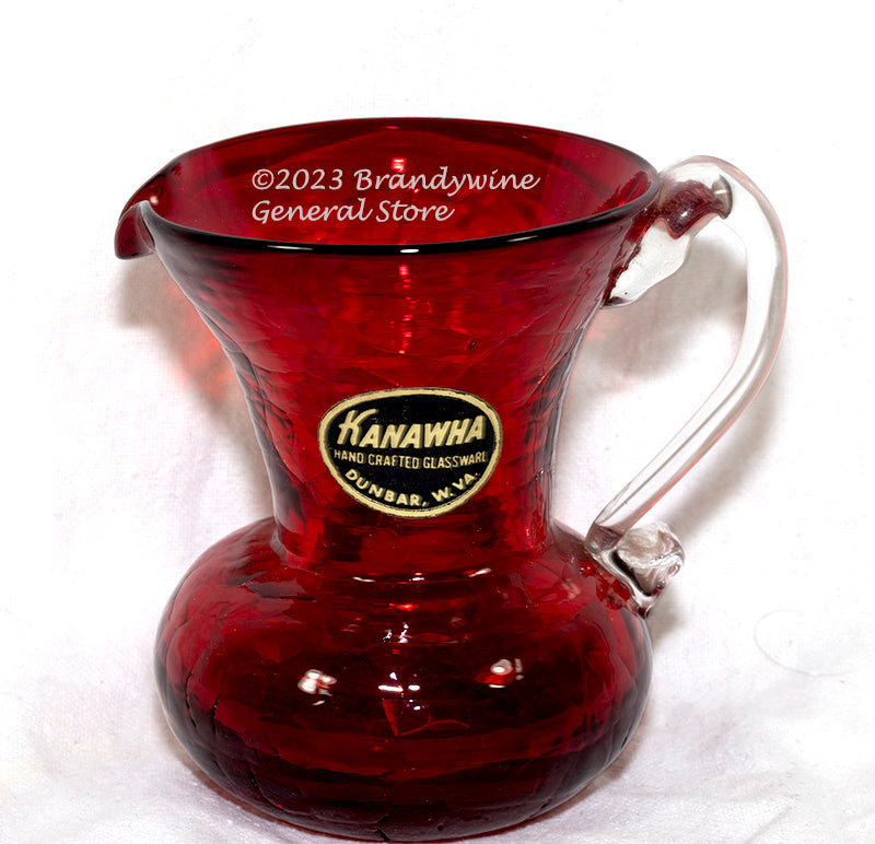 A small Kanawha hand blown deep ruby pictcher with clear glass applied handle