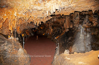 A fine art print of a yawning chasm with many formations in Luray Caverns