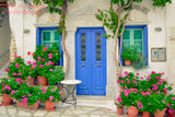A botanical art print of Geraniums with Pink Blooms in front of a Blue Doors